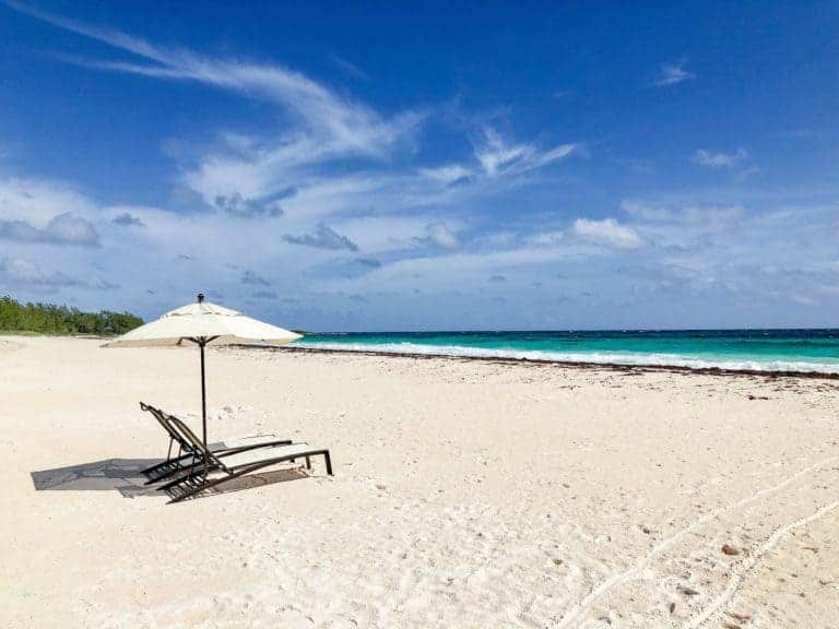 The white sand beach and turquoise water of French Leave Beach is a wonder to take in from the provided lounge chairs and umbrella