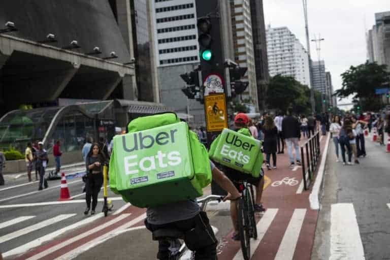 Uber Eats cycle delivering food carried in backpacks.