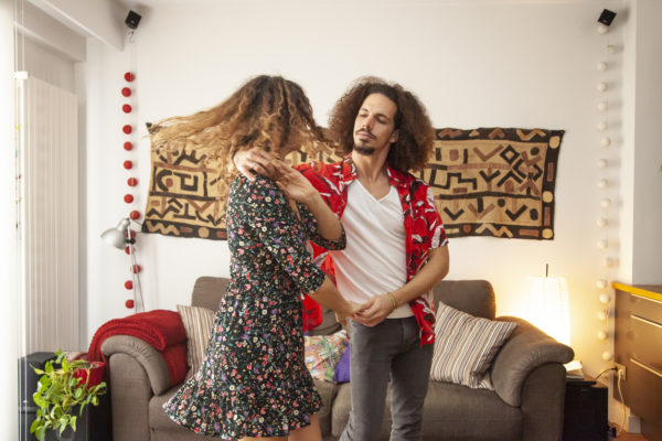 Lovely couple having fun dancing at home.