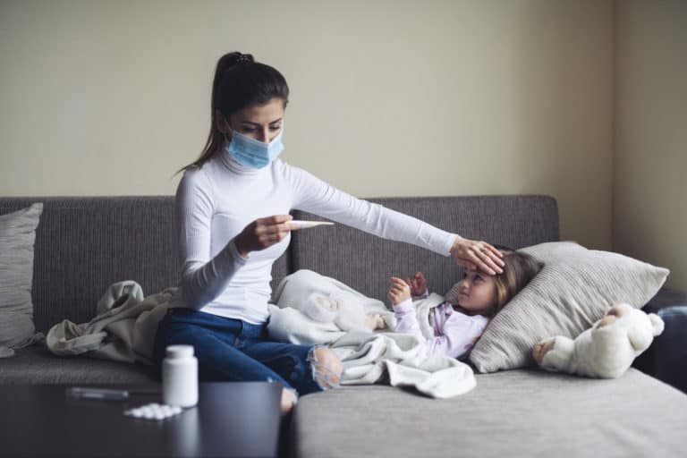 A Mother Measure Temperature On Her Sick Child