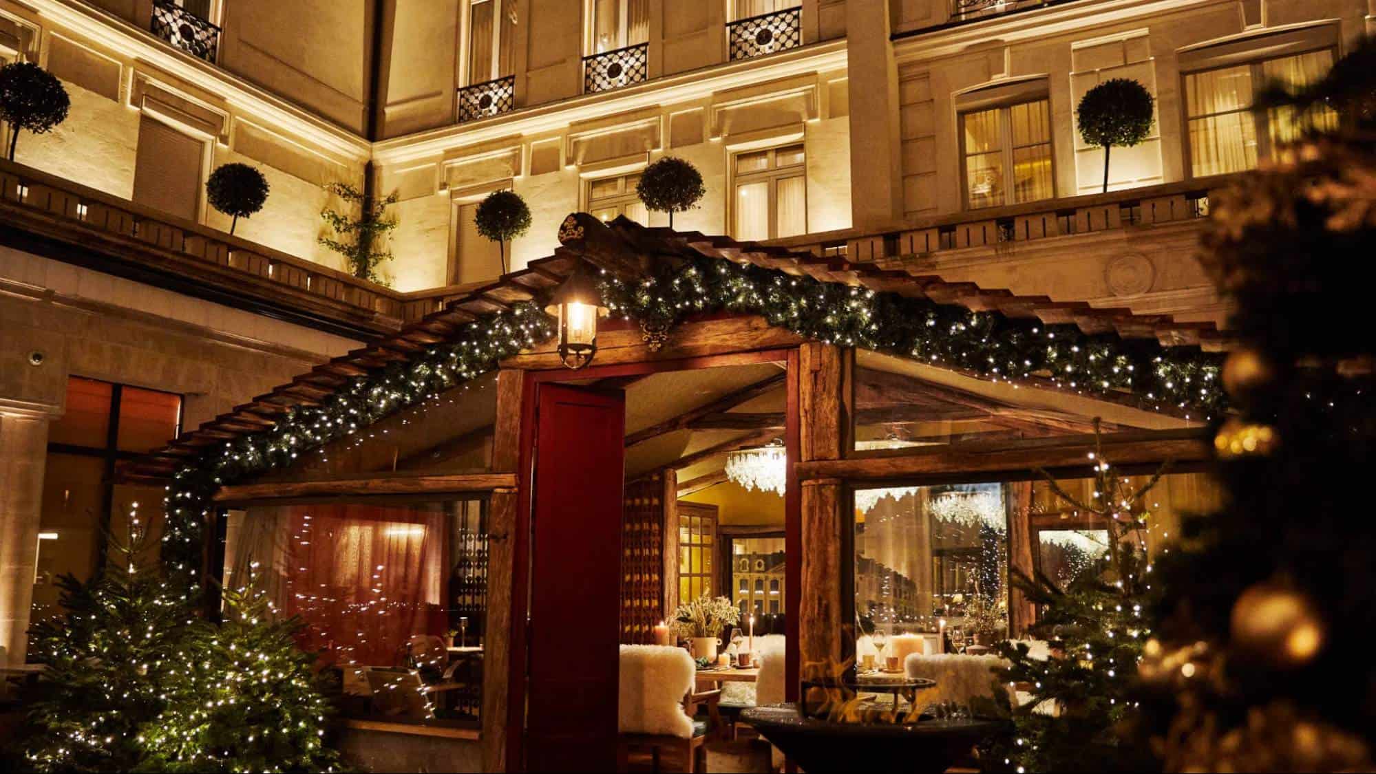 Festive winter terrace at Park Hyatt Paris–Vendôme illuminated with warm lights, holiday décor, and an elegant outdoor dining pavilion at night
