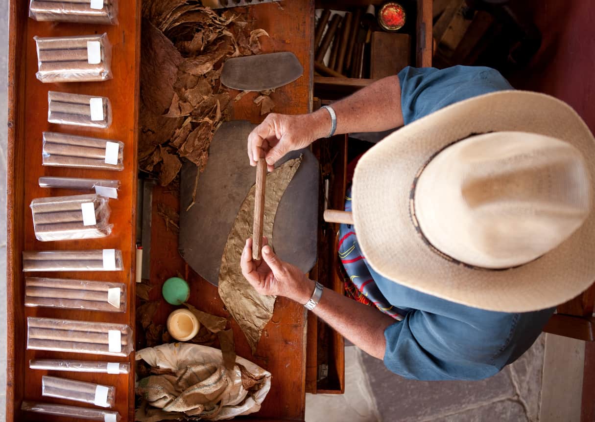 Cuban man rolling cigar