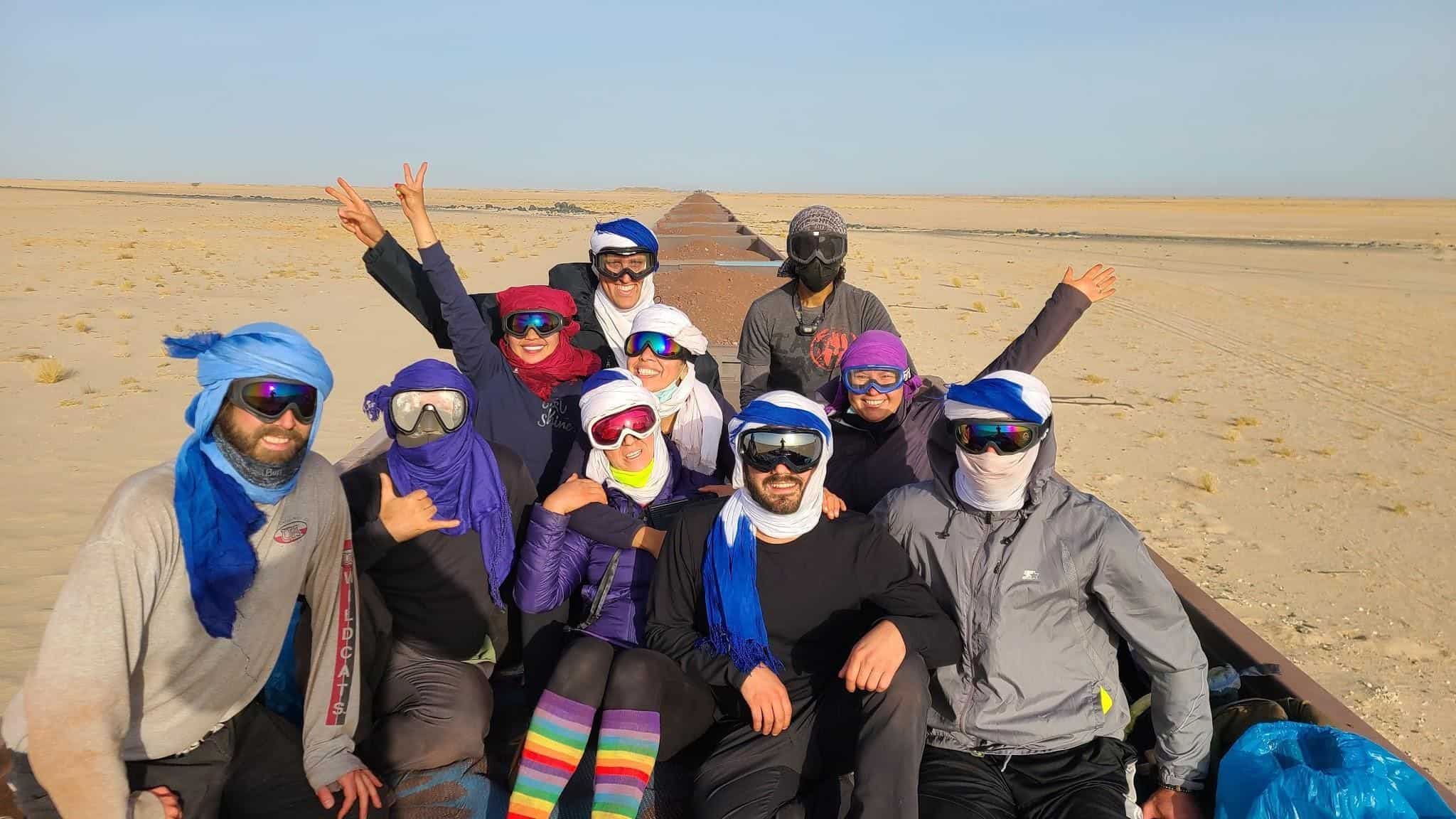 A group of adventurers rides the iron ore train from Choum to Nouadhibou, Mauritania.