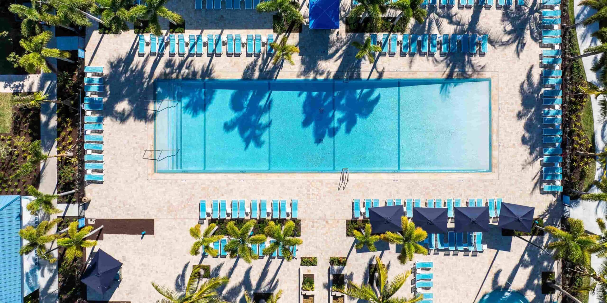 Aerial view of pool and lounge chairs at voco Sandpiper All-Inclusive Resort in Port St. Lucie, Florida