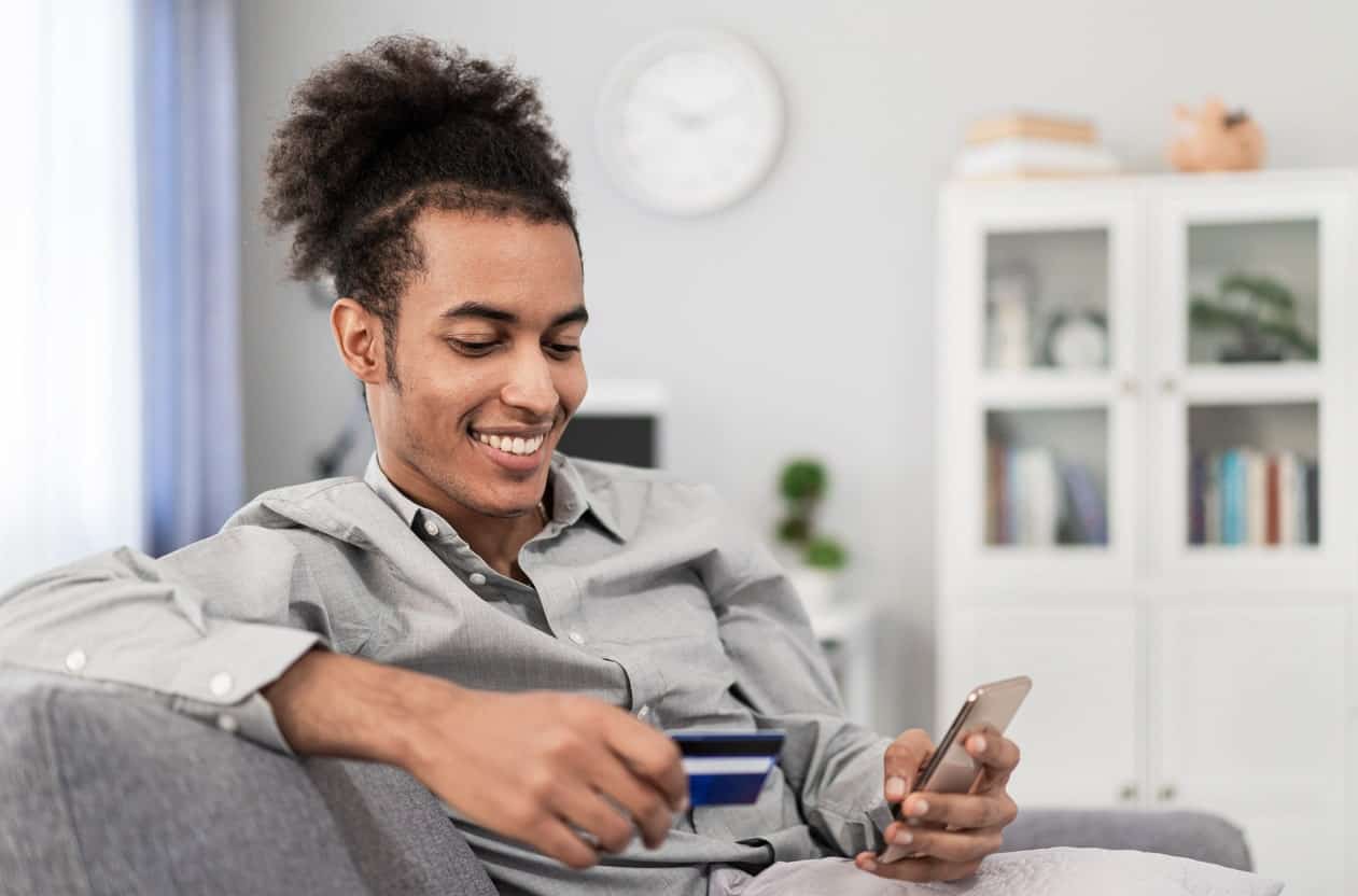 Using Chase Sapphire Preferred credit card for an online purchase, earning travel rewards from home.