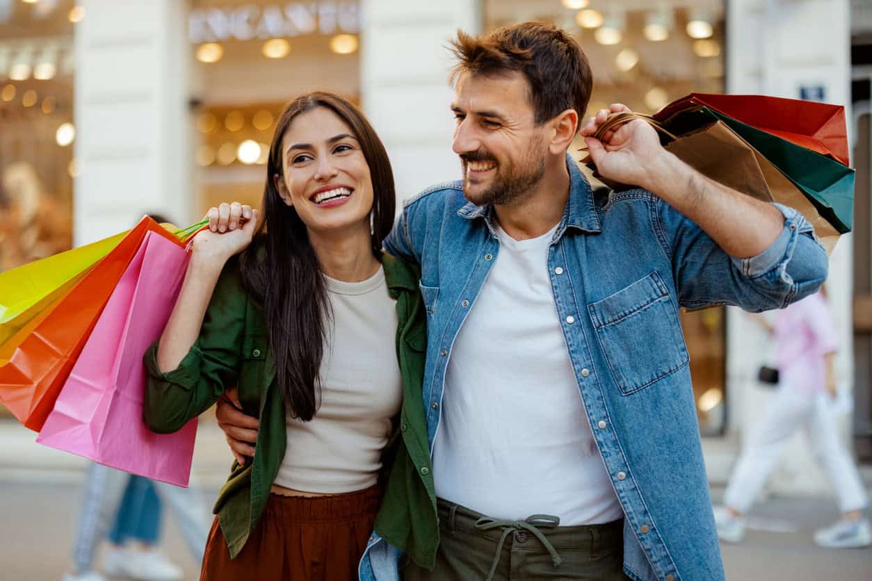 appy couple carrying shopping bags, representing credit card rewards and shopping perks
