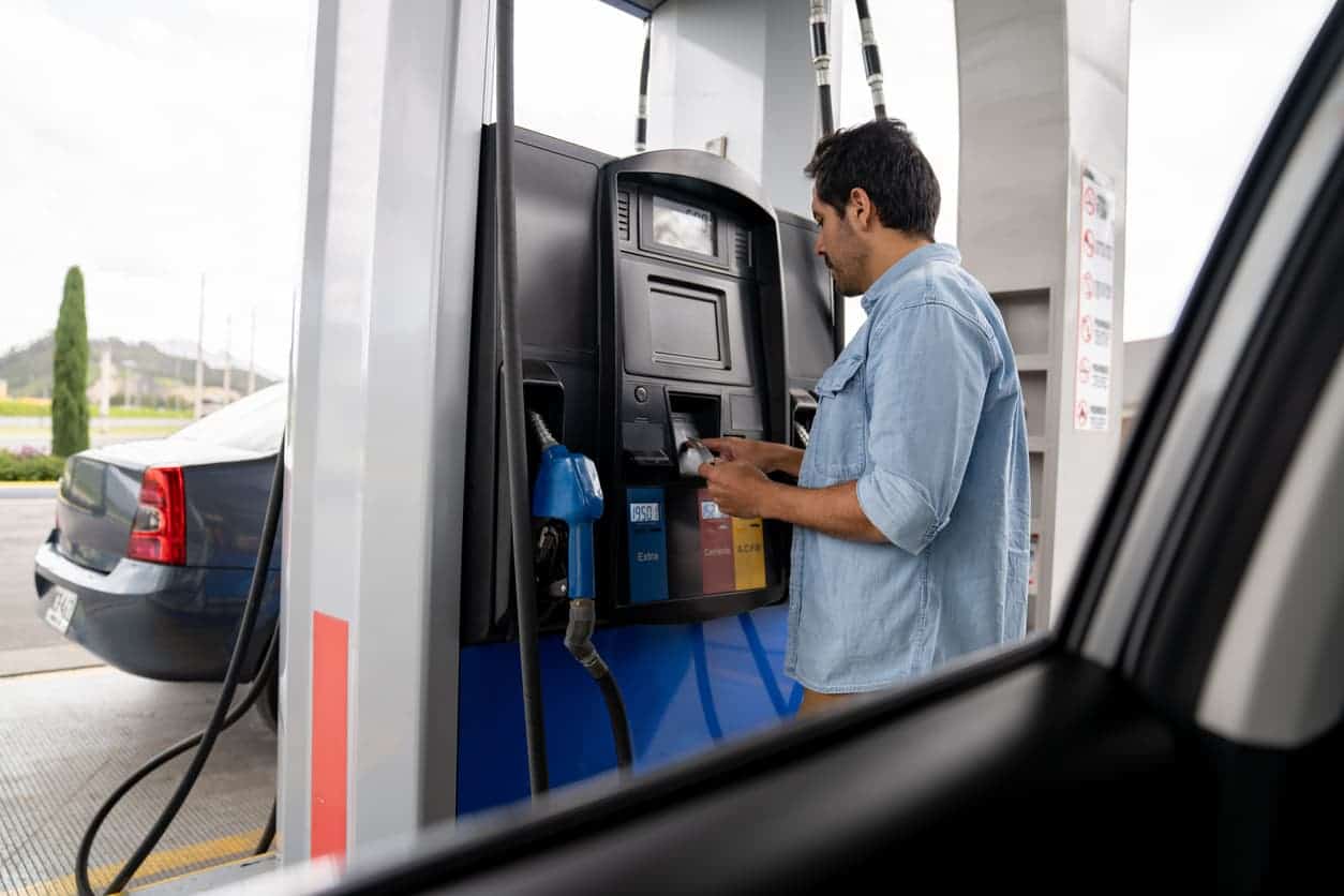 Man using a credit card to pay at a gas station pump