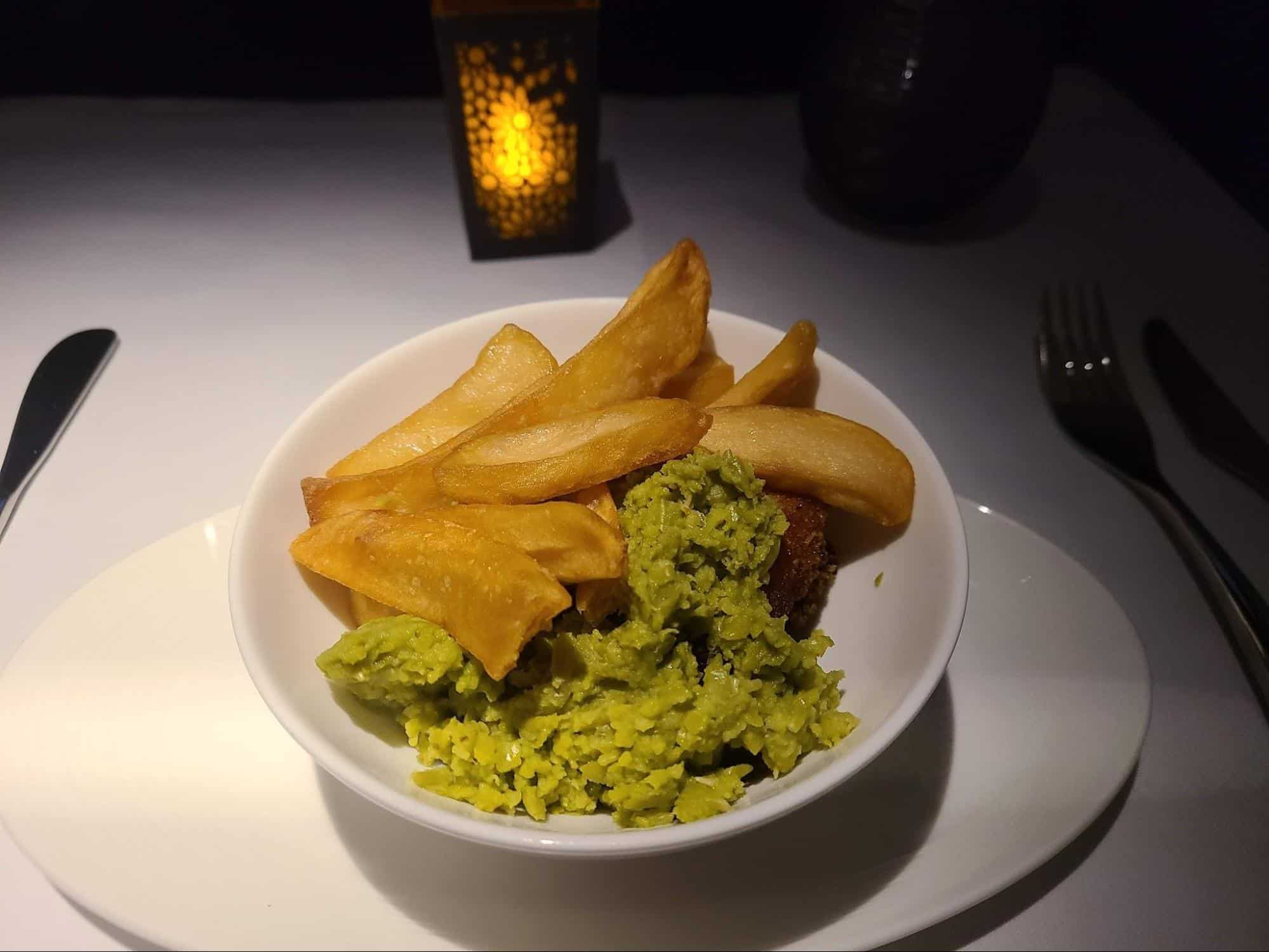 Fish and chips and mushy peas onboard Qatar Qsuites business class