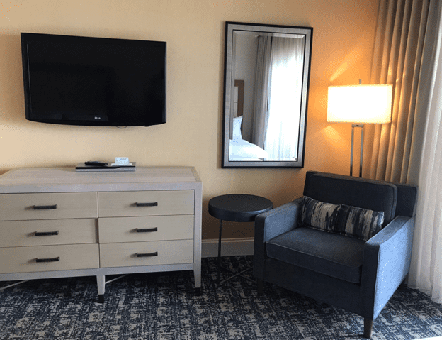 Oceanfront one bedroom suite dresser, television and chair