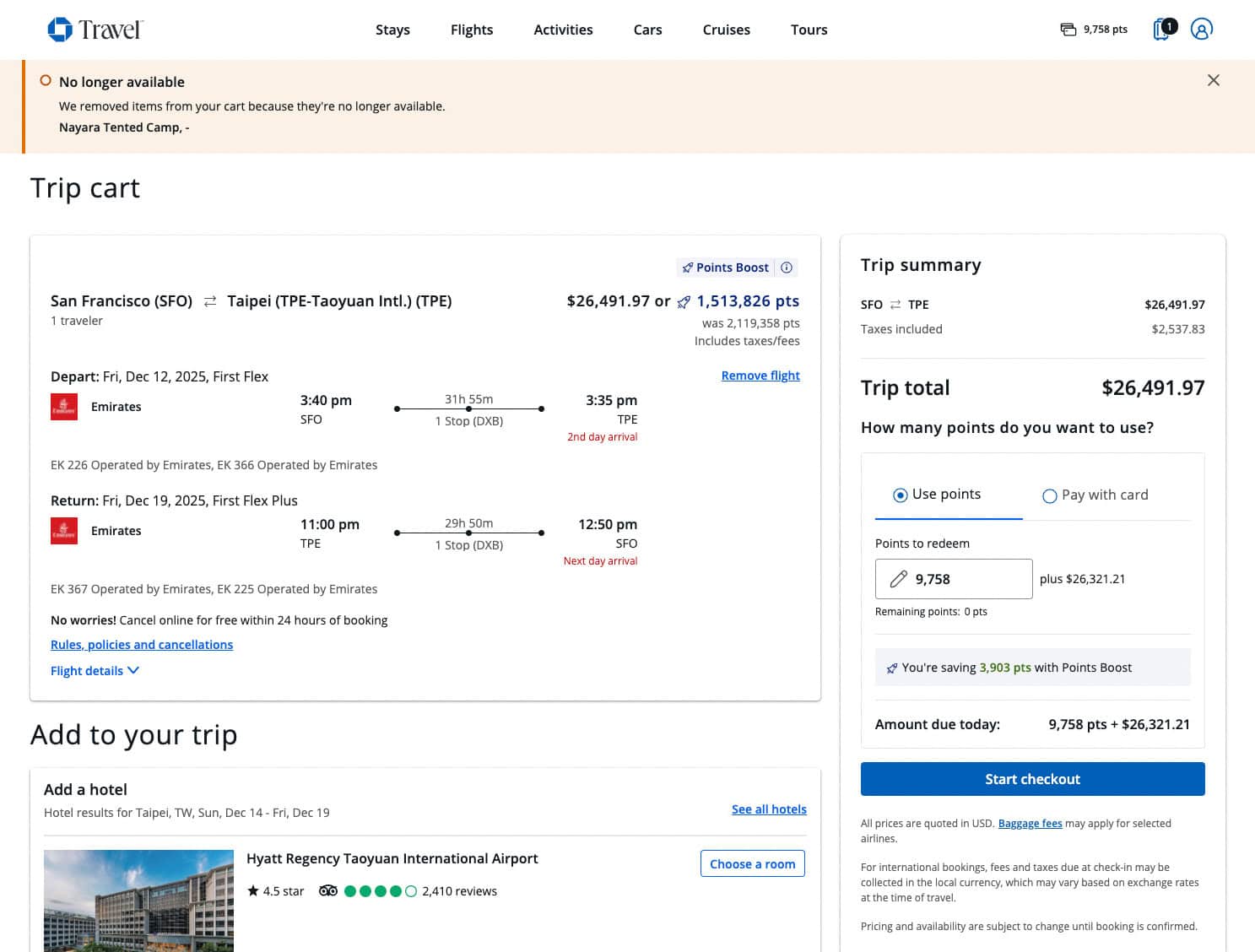 Trip checkout page comparing points redemption vs. cash payment for an Emirates first class flight booking