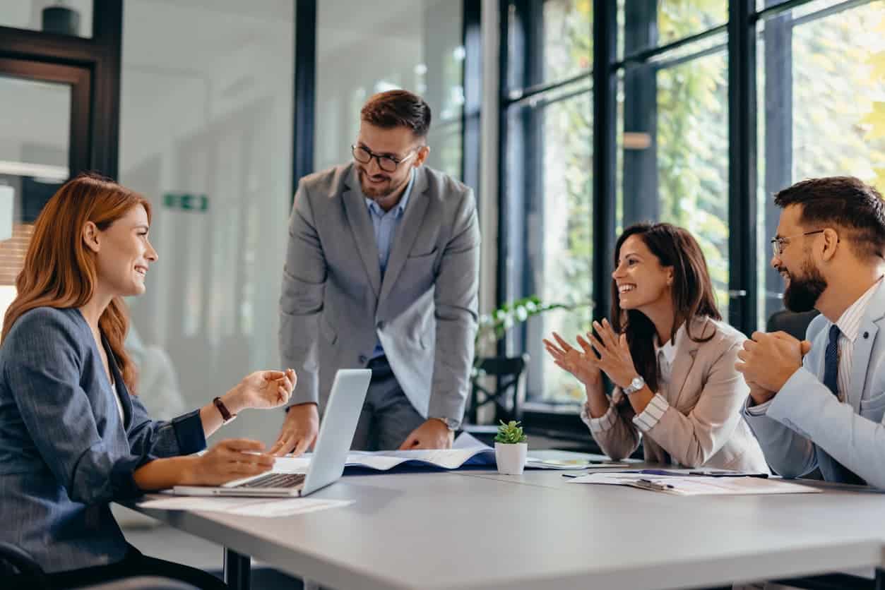 Group of business professionals in a modern office having a team discussion and collaboration meeting.