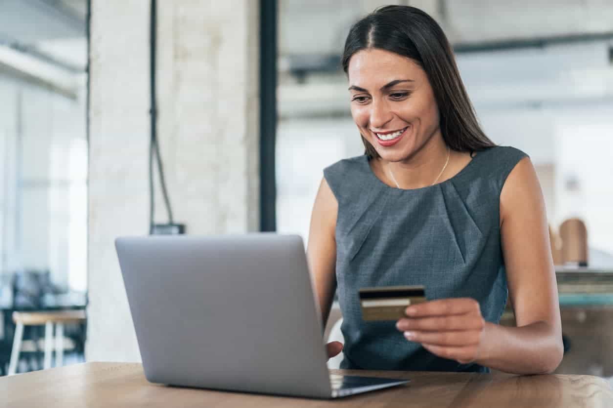 Employed woman using a credit card.
