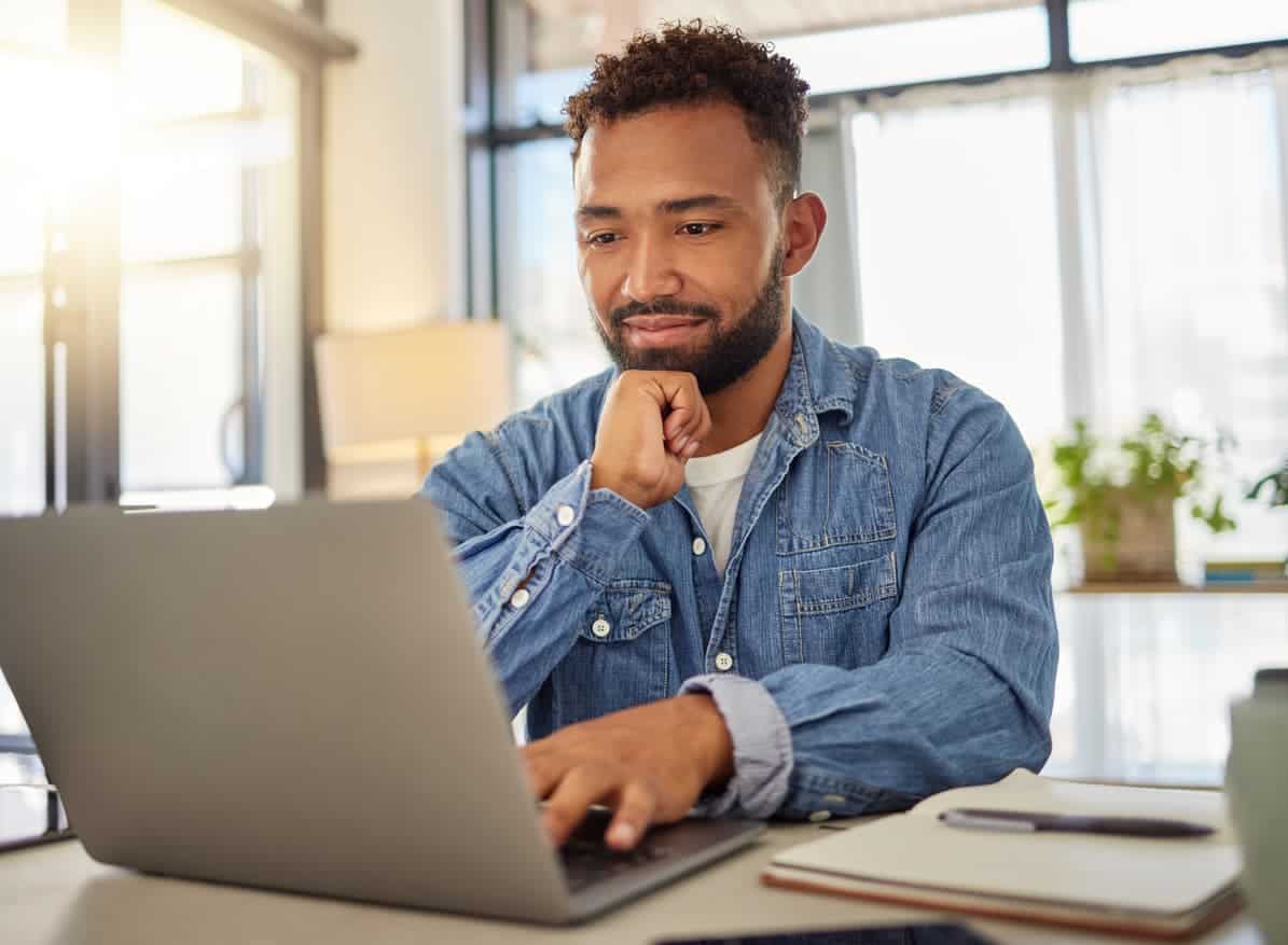 Man using laptop to manage multiple credit cards on an online dashboard