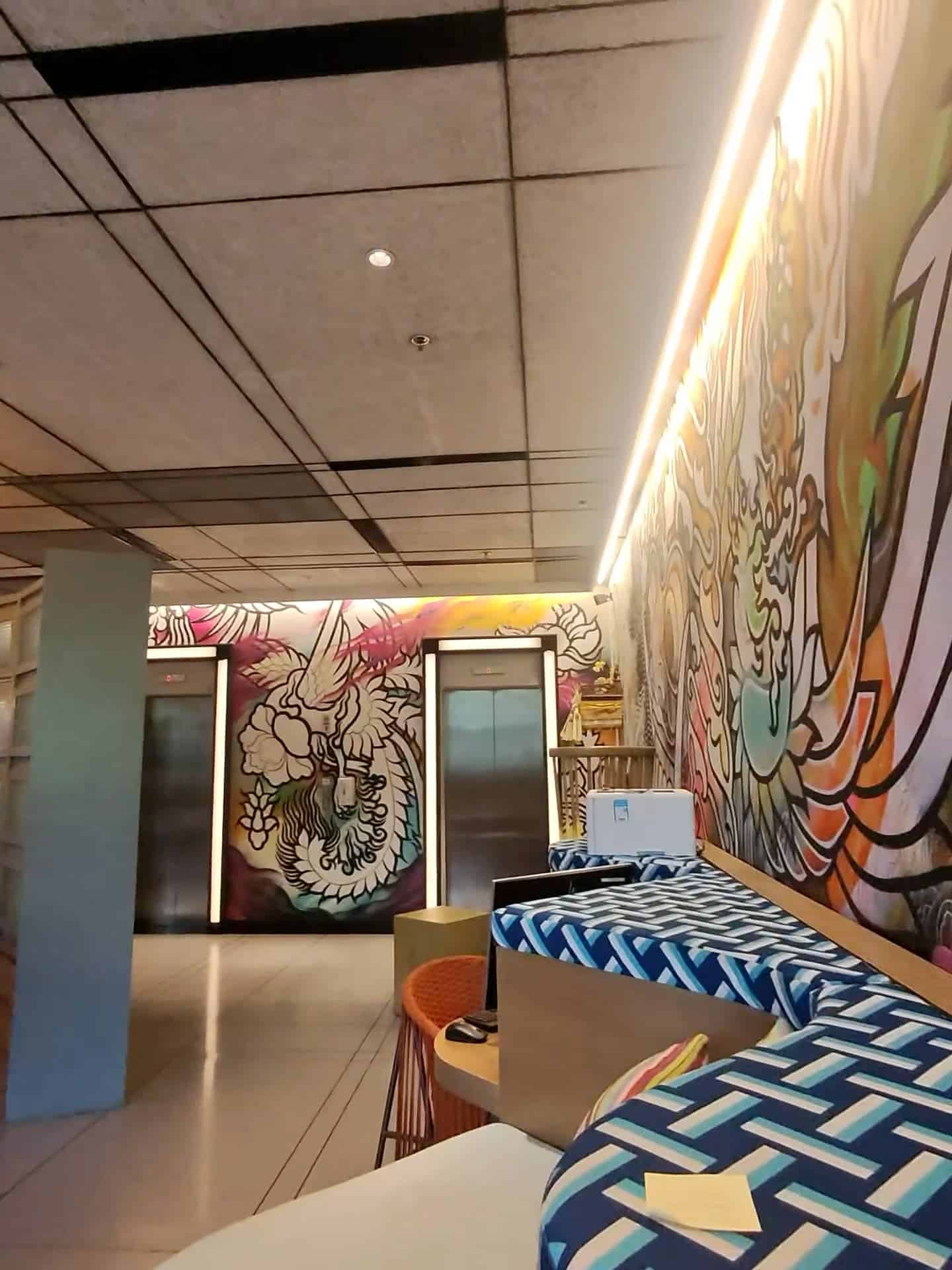 Colorful graffiti-style wall art in the lobby area at Aloft Bali Seminyak