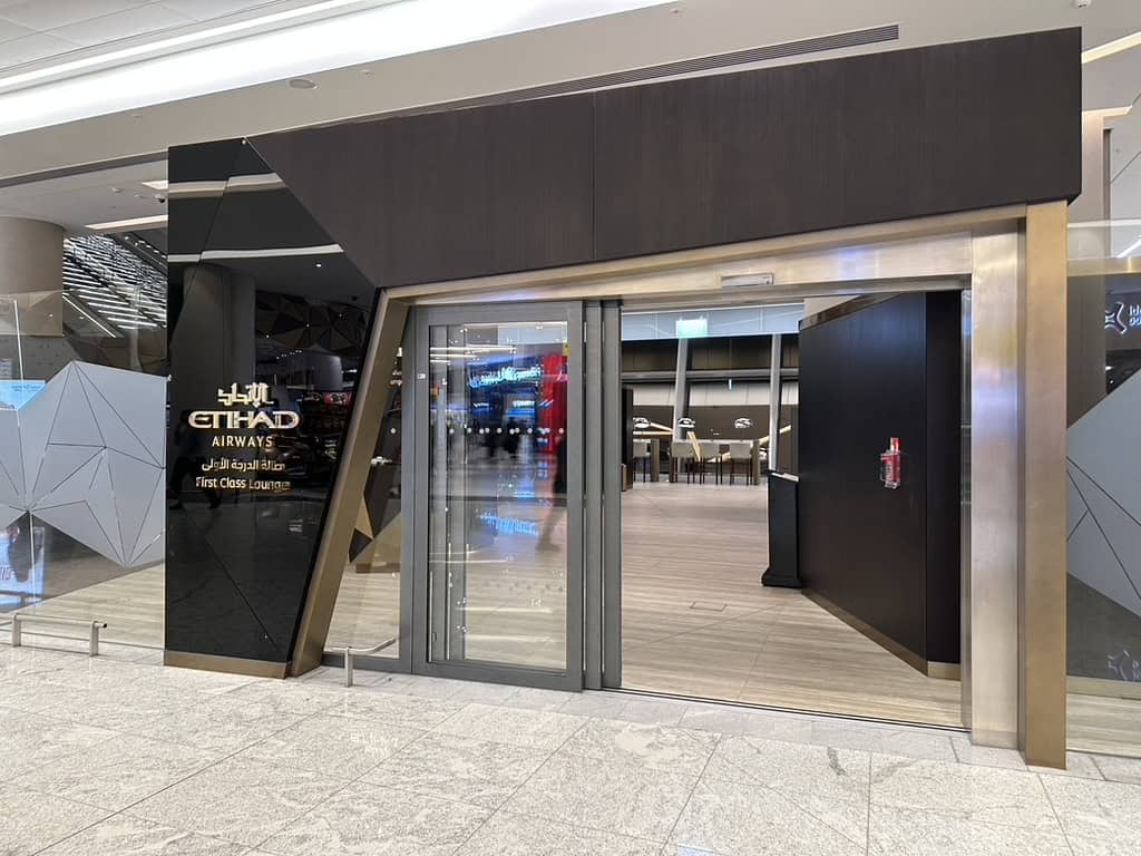 Entrance to the Etihad Airways First Class Lounge with modern geometric design and glass doors