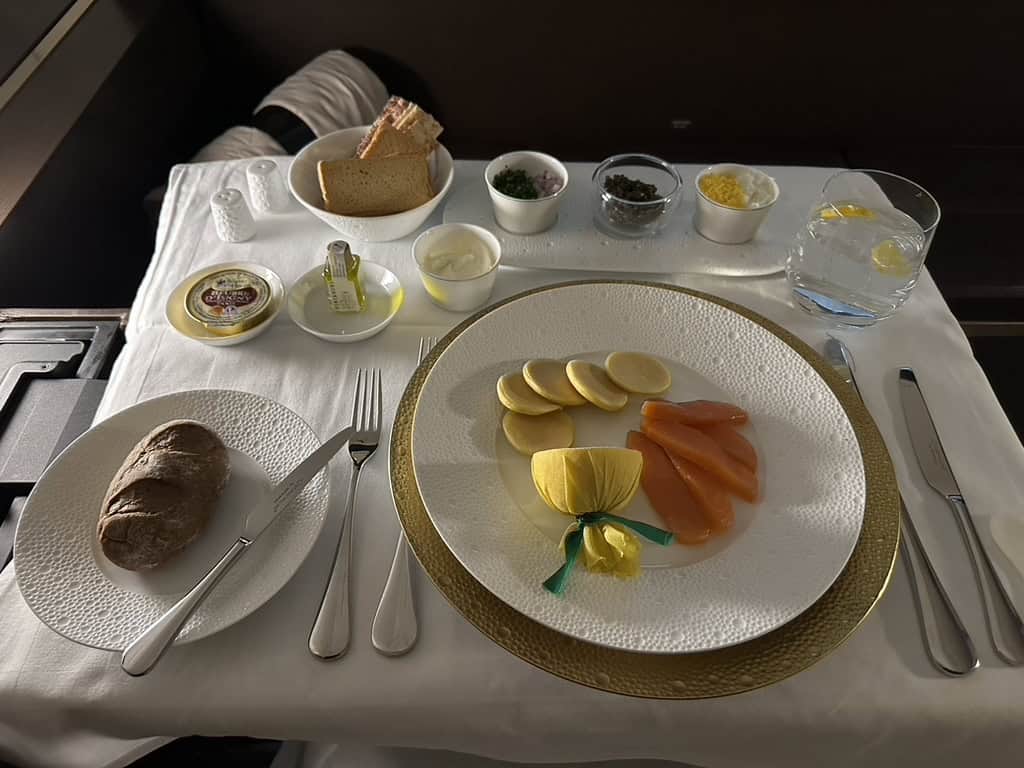 Etihad Airways First Class appetizer with caviar, smoked salmon, and bread rolls