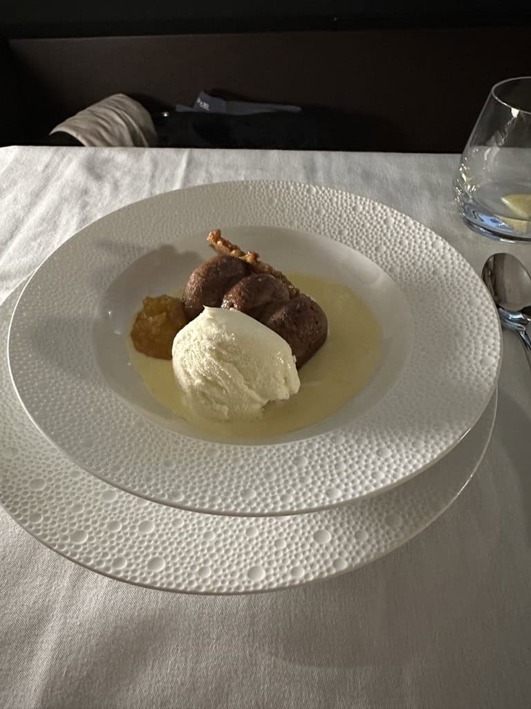 Etihad Airways First Class dessert with ice cream and sauce served elegantly