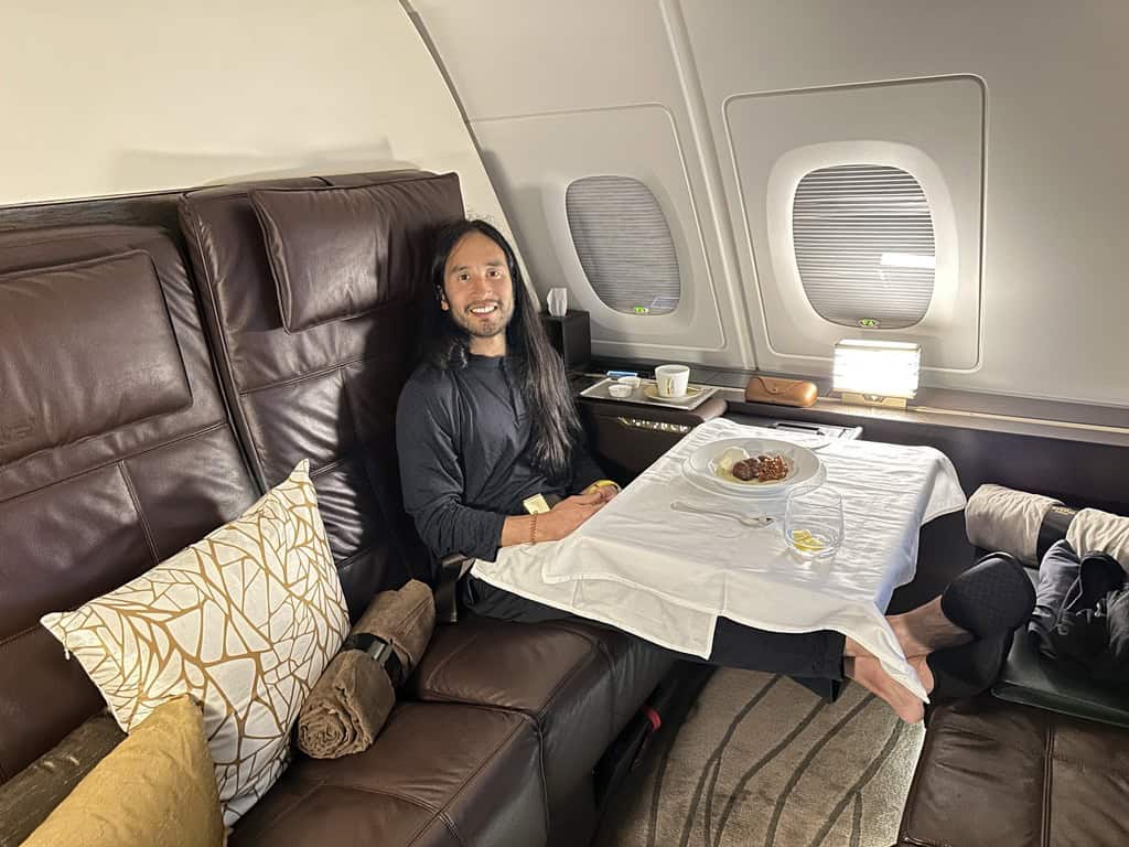Passenger dining in Etihad Airways First Class suite with luxury service