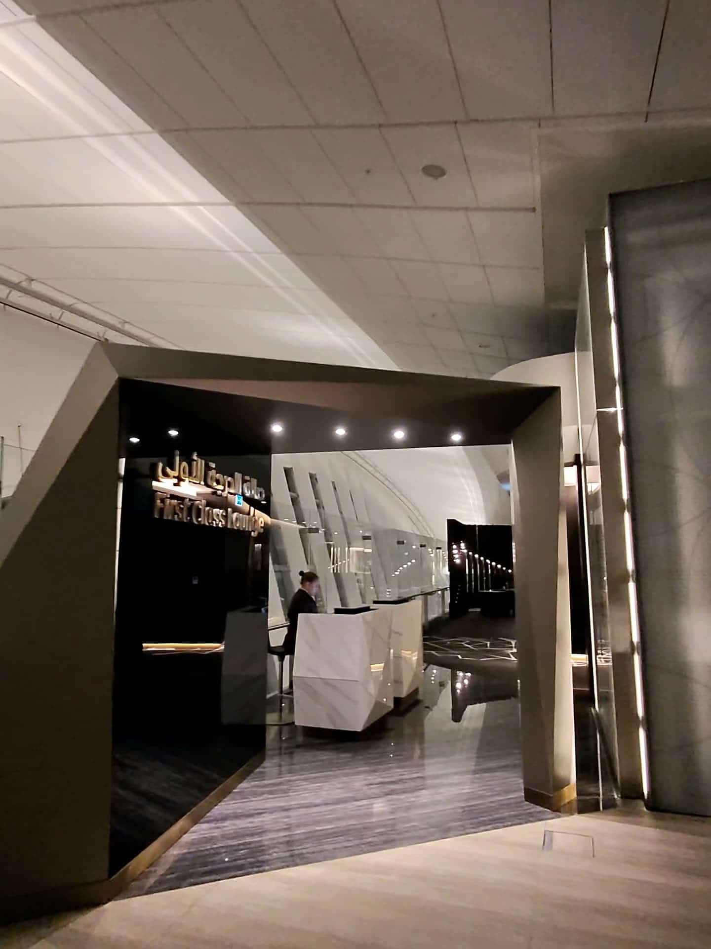 Reception area of Etihad Airways First Class Lounge with modern lighting and marble design