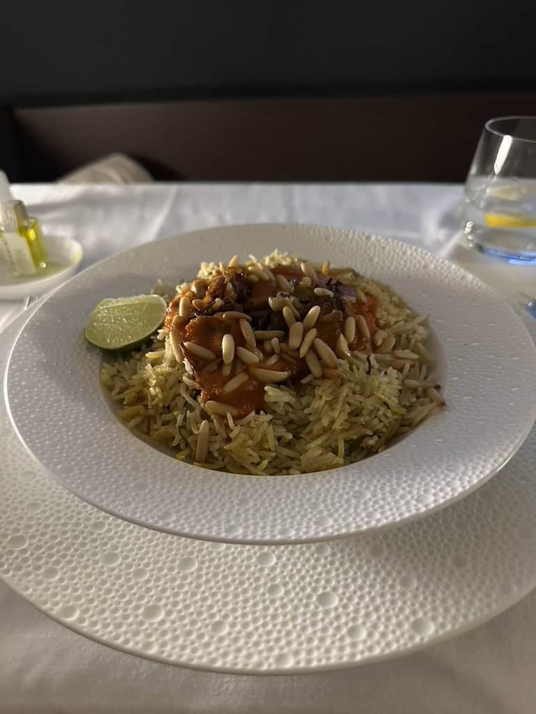 Etihad Airways First Class main course featuring Middle Eastern rice with nuts