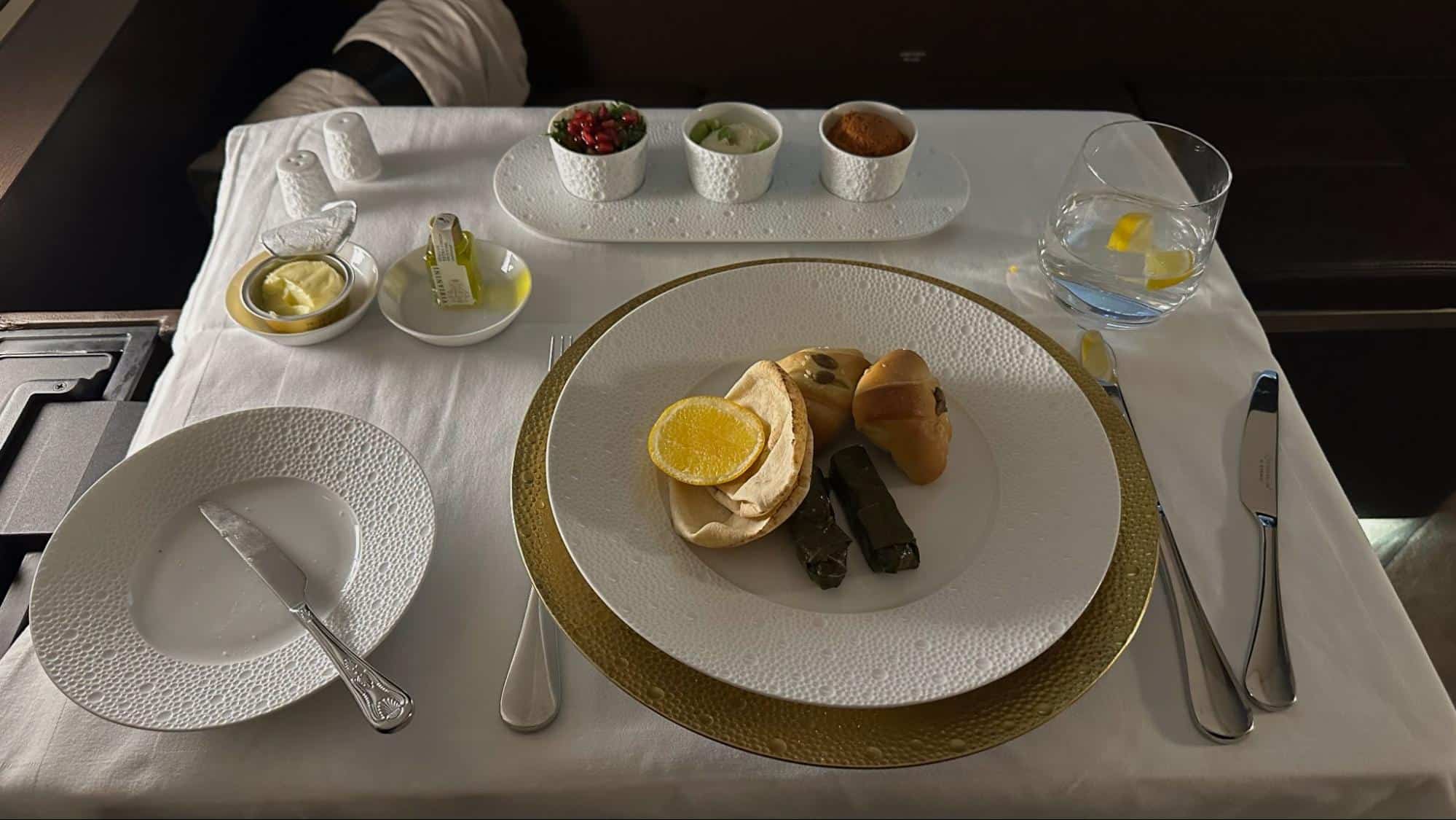 Etihad Airways First Class Arabic mezze platter with bread, dips, and lemon garnish