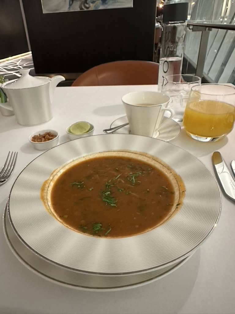 Hot soup course served on elegant tableware at Etihad Airways Lounge restaurant