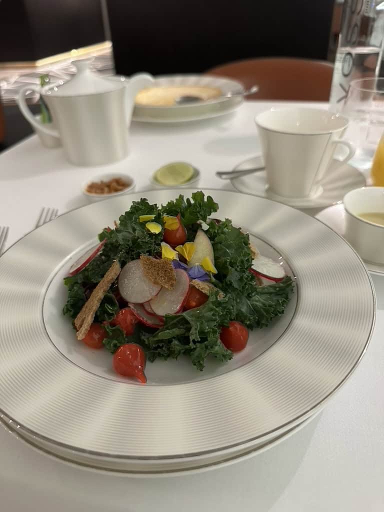 Fresh mixed salad with kale, radish, and edible flowers served at Etihad Airways Lounge