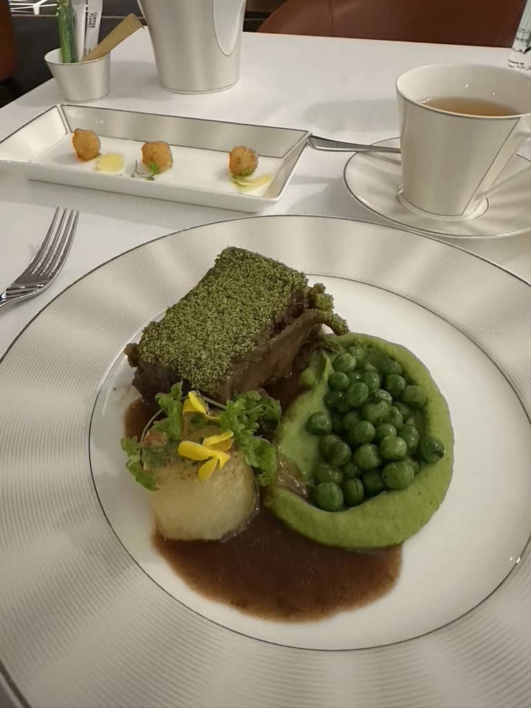 Gourmet main course with green pea puree and beef served at Etihad Airways Lounge