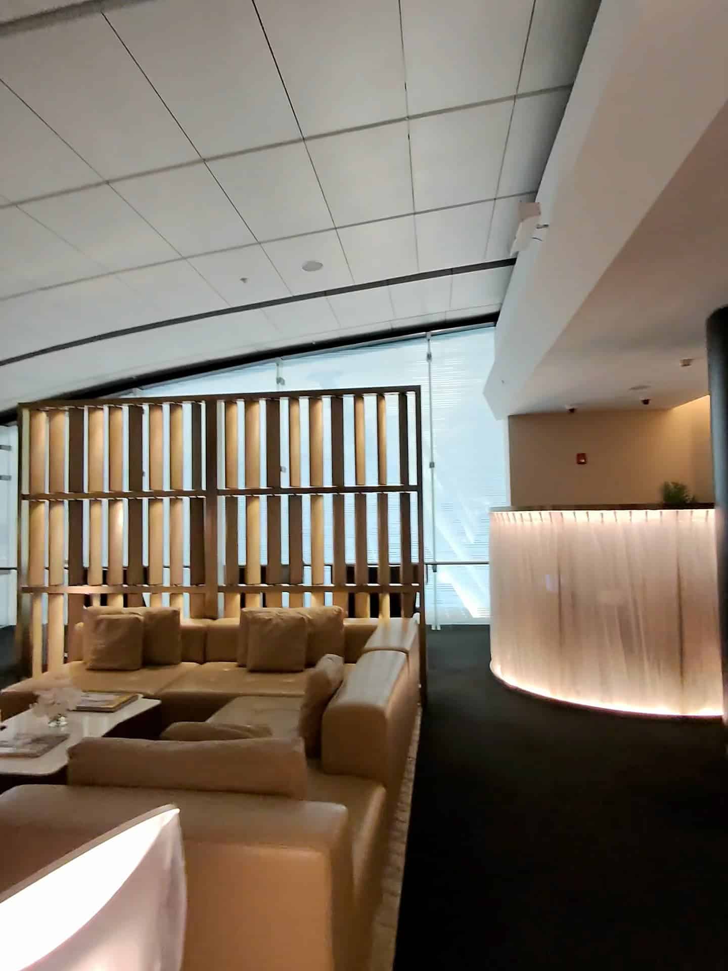 Private seating area with modern lighting and couches at Etihad Airways Lounge