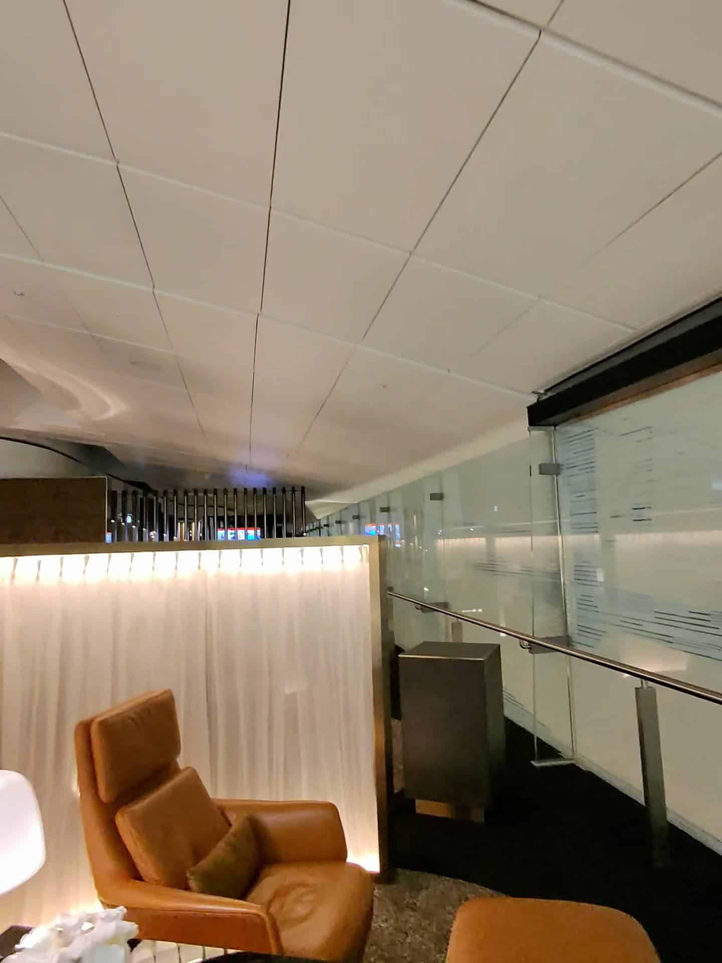 Relaxation corner with leather chair and soft lighting at Etihad Airways Lounge