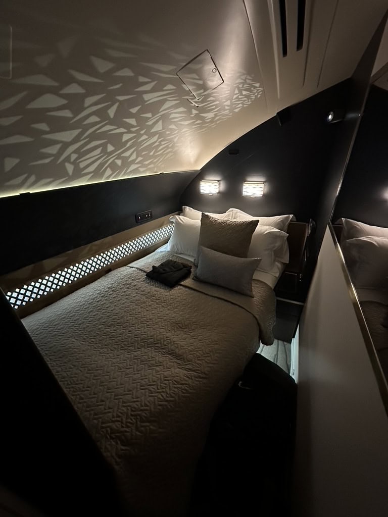 Etihad Airways The Residence private bedroom with premium bedding and ambient lighting