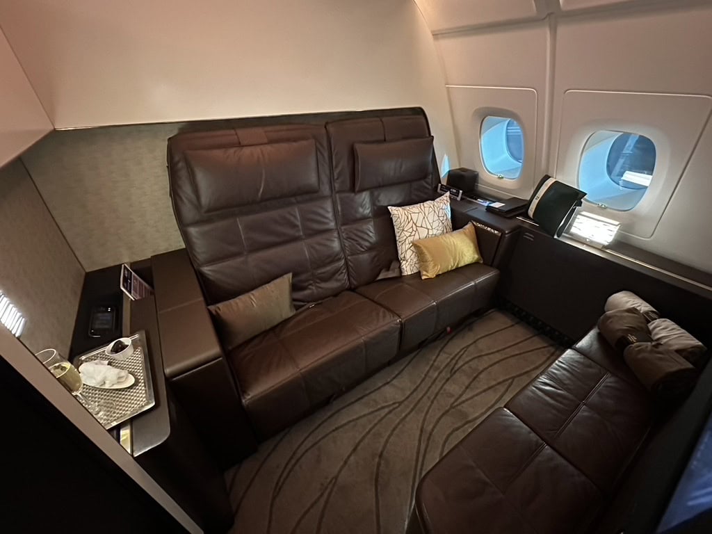 Etihad Airways The Residence living room with leather sofa and window views
