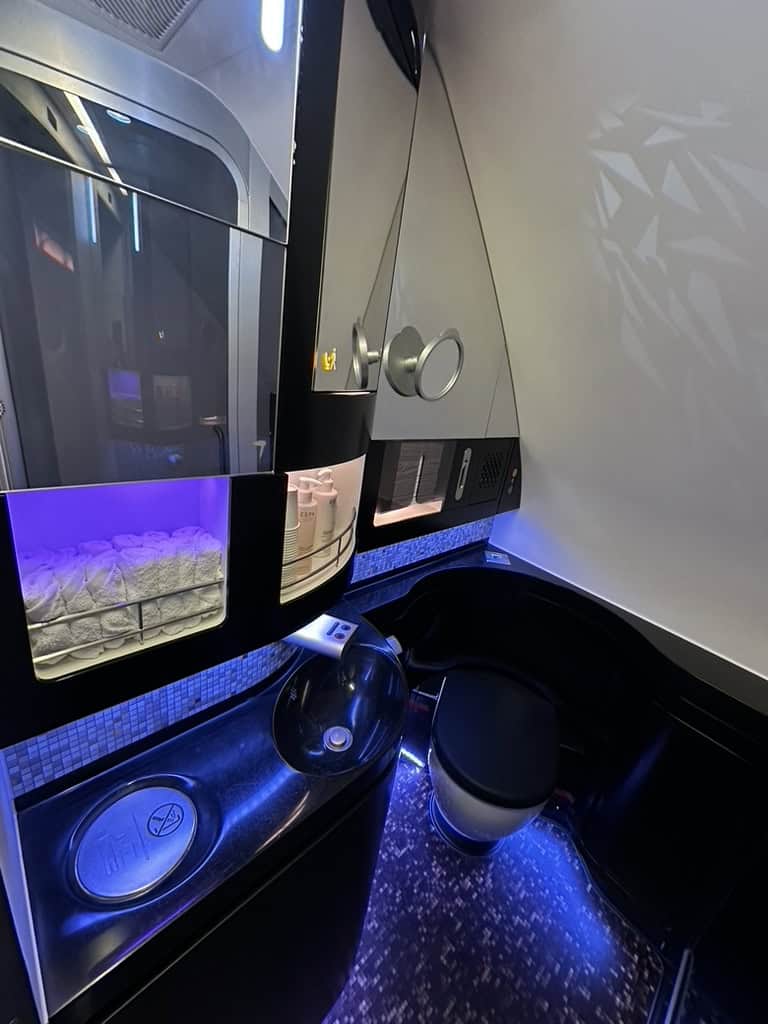 Etihad Airways The Residence private bathroom with elegant lighting and modern fixtures