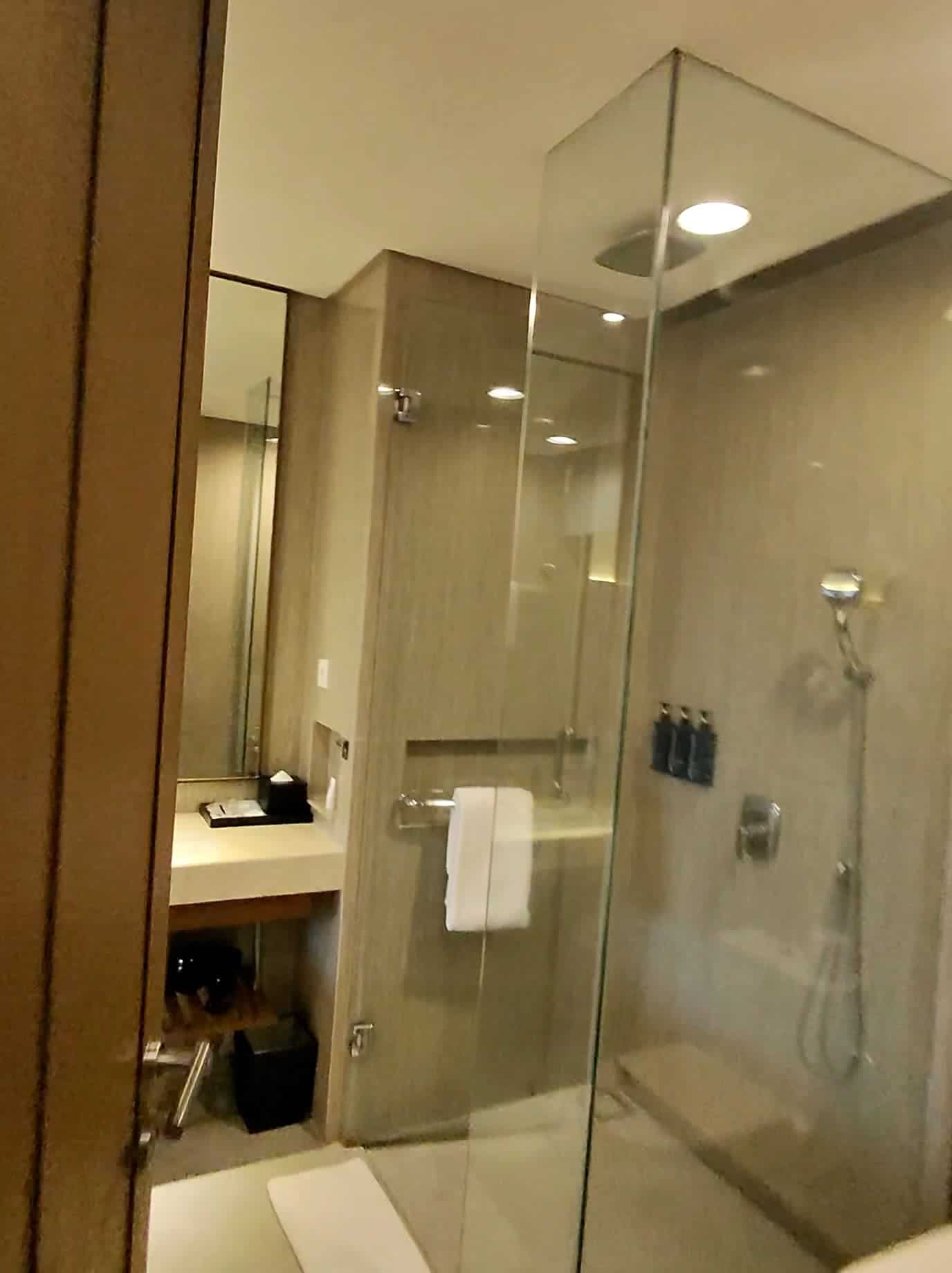 Elegant bathroom with glass shower at Four Points by Sheraton Bali Seminyak