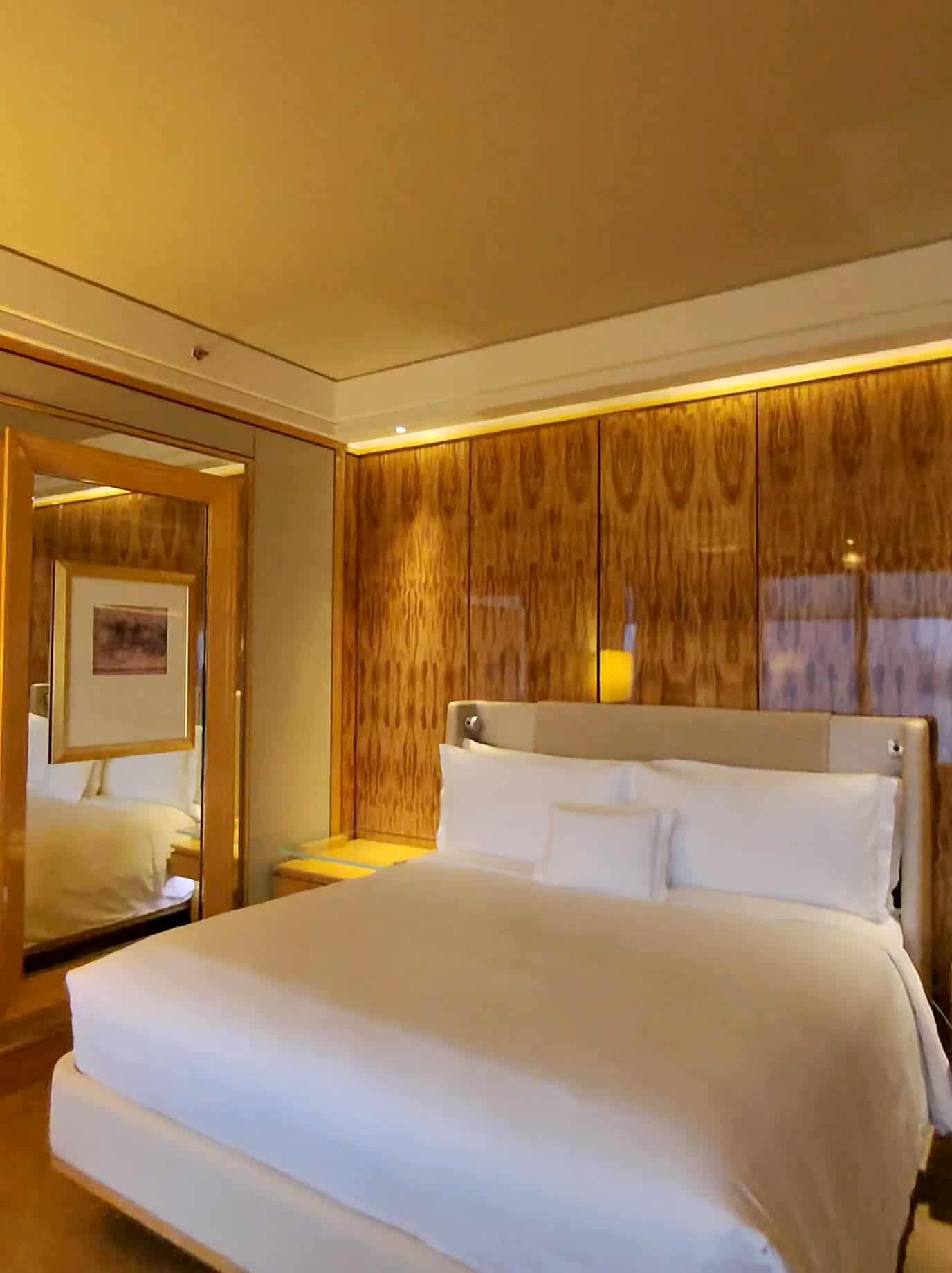 Elegant hotel bedroom with warm lighting and wooden interiors in Singapore