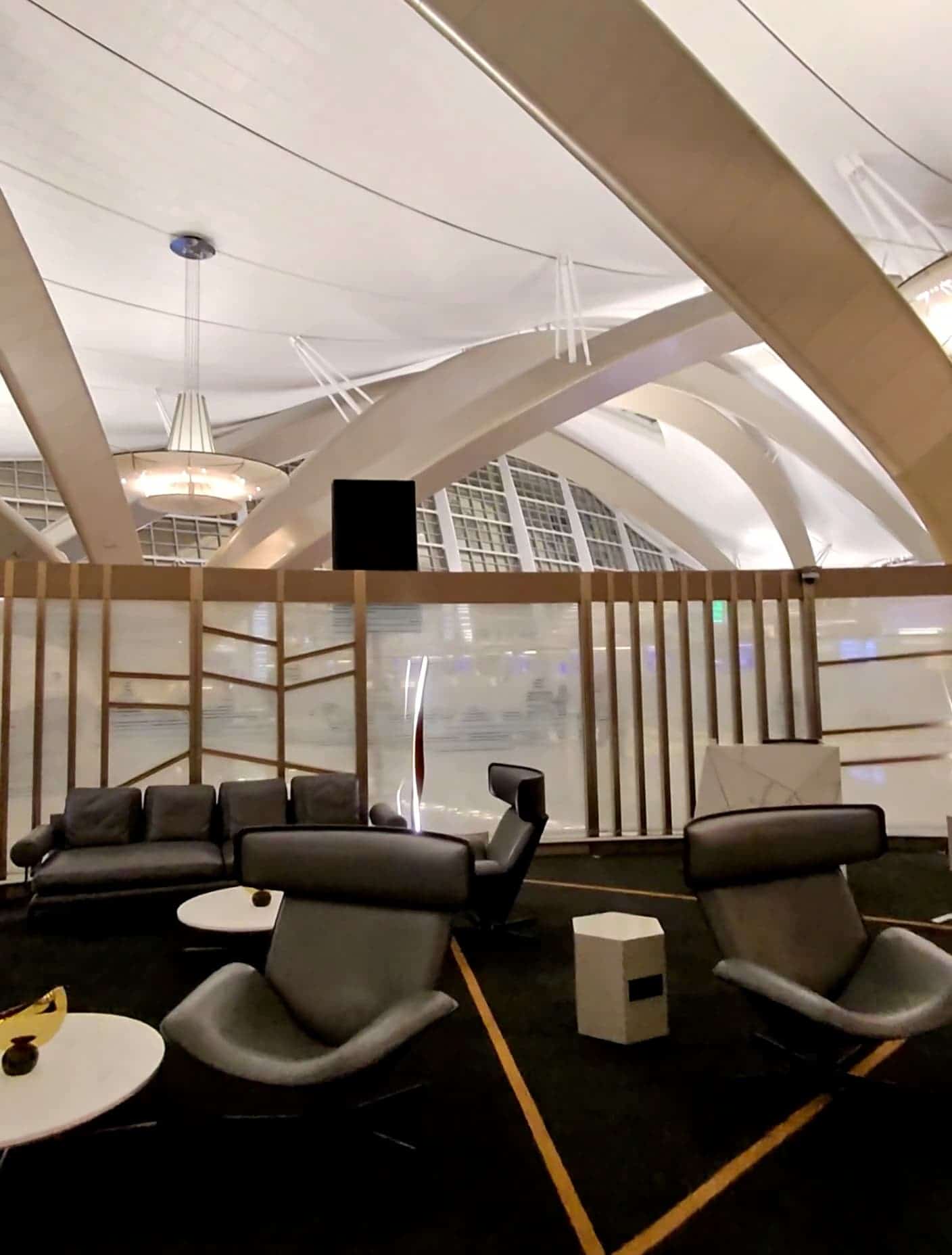 Modern luxury airport lounge interior with comfortable leather chairs and elegant ceiling design