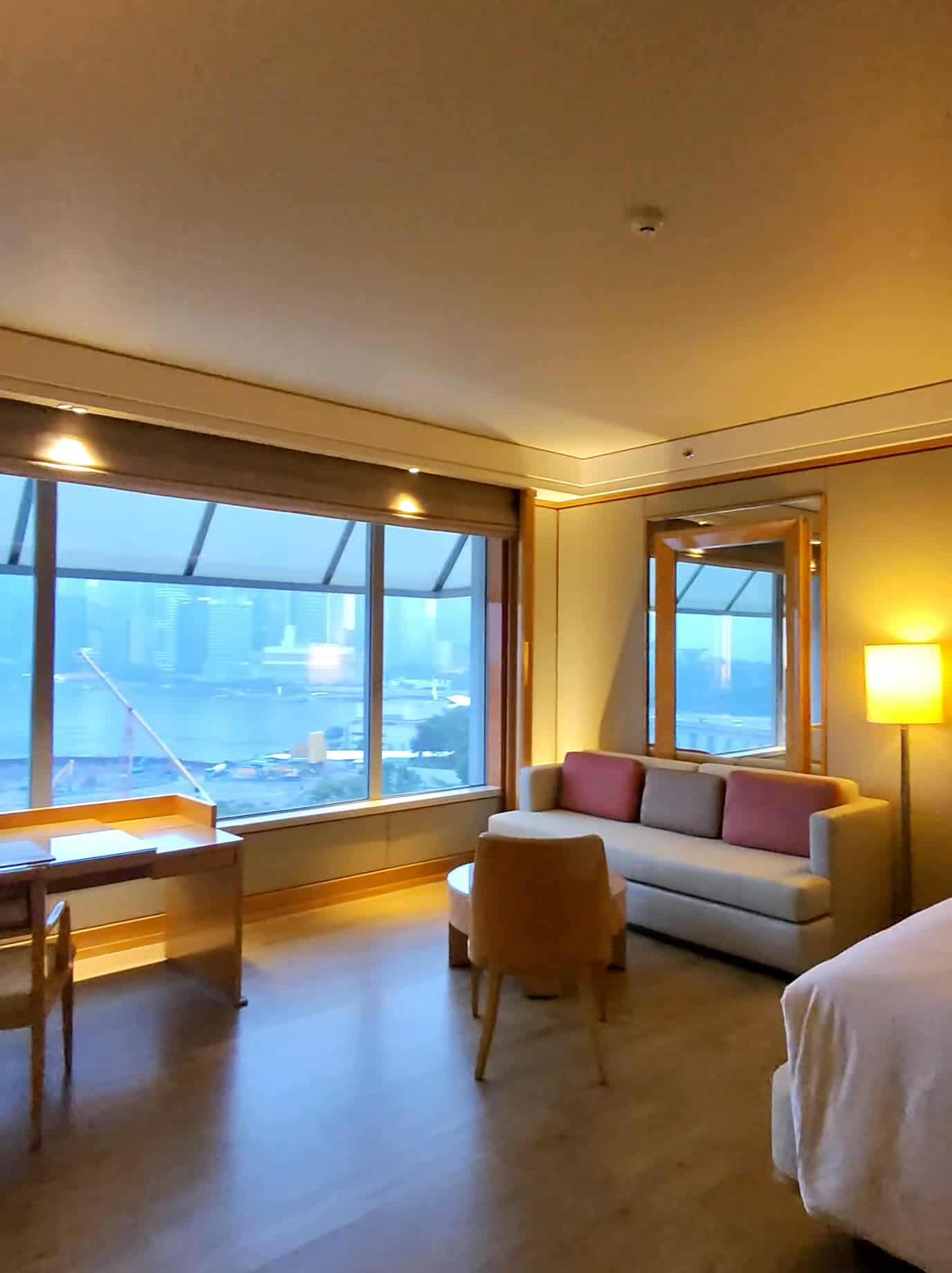 Cozy hotel suite with a large window overlooking Marina Bay in Singapore