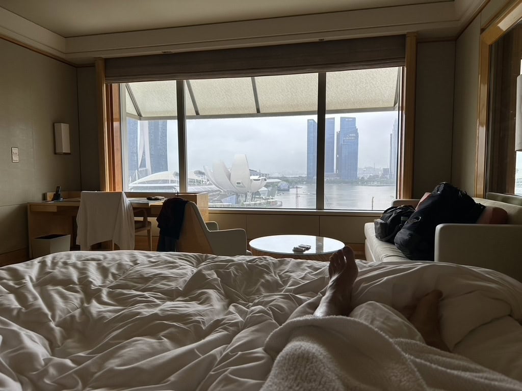 Relaxing morning view from a hotel bed overlooking Marina Bay Sands and ArtScience Museum in Singapore