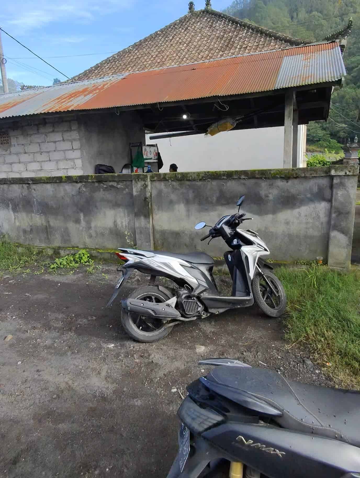 Scooter parked near a rural home, typical starting point for Mount Batur adventures in Bali