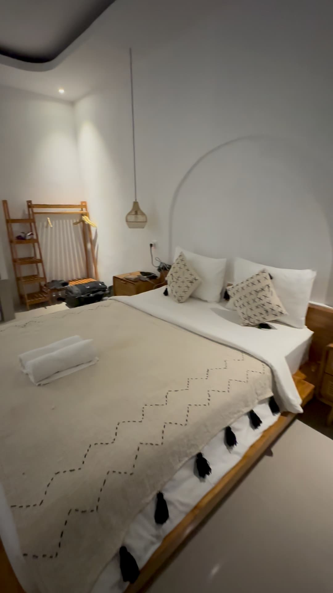 Cozy bedroom with minimalist decor and natural tones at Volcano Garden View in Bali