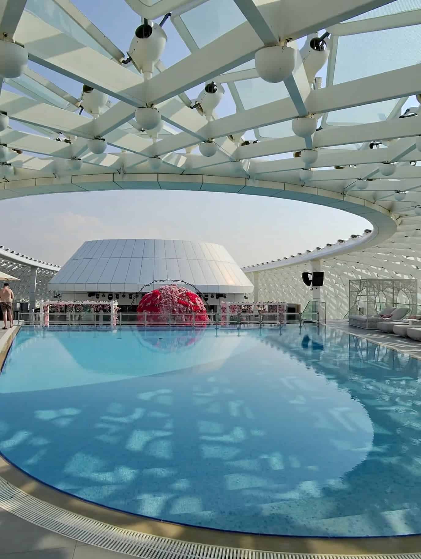 Rooftop swimming pool at W Abu Dhabi with futuristic dome structure and reflections on the water