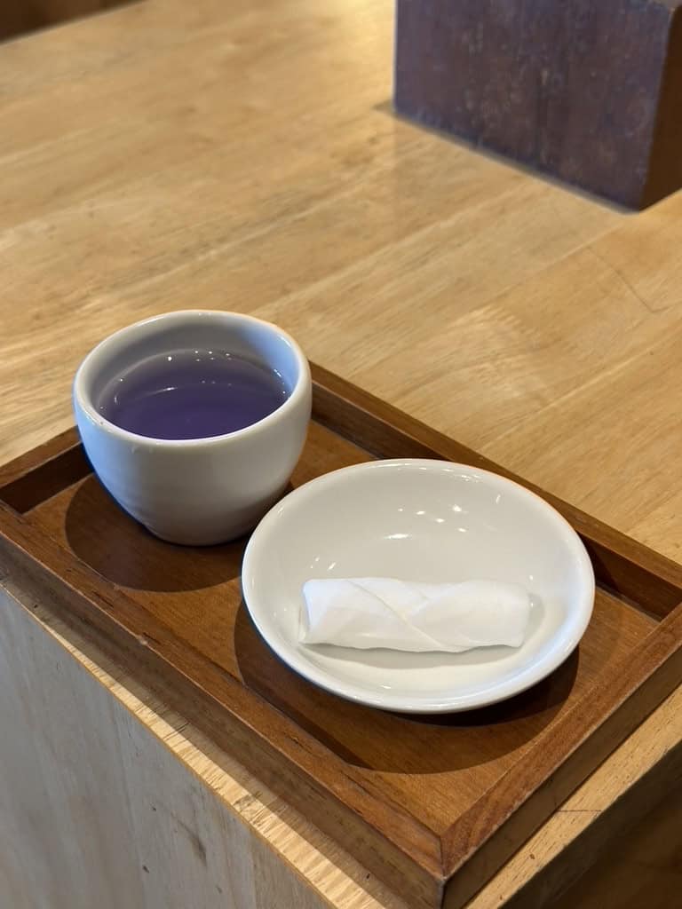 Cup of butterfly pea tea and hand towel served as a welcome drink at a Bali spa
