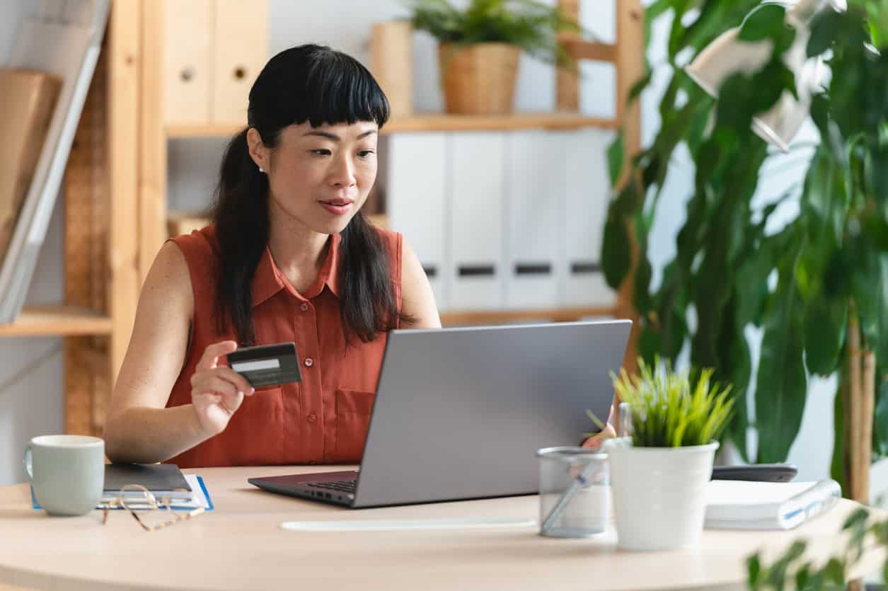 Business owner paying her bills with a credit card