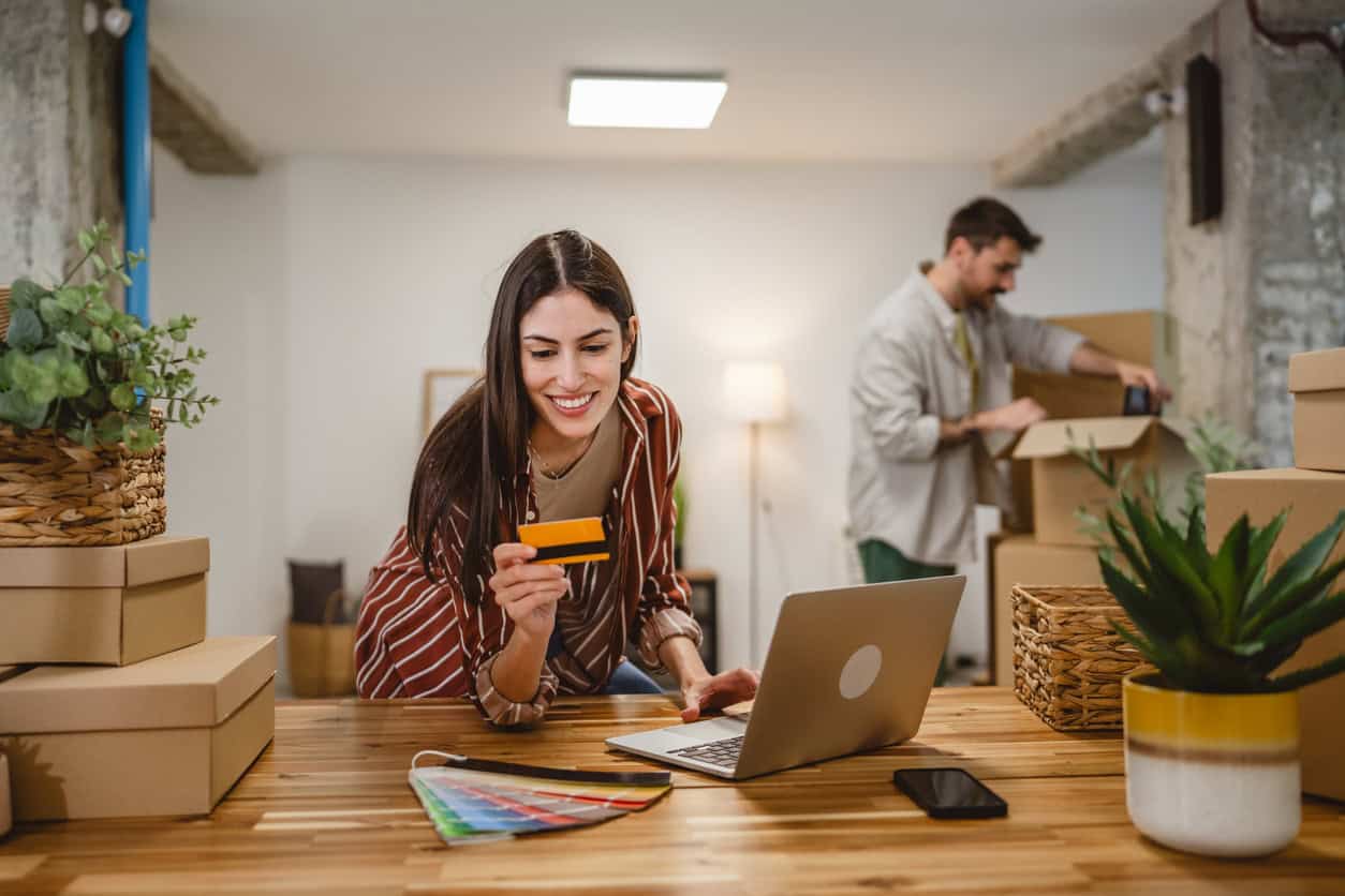 Business owners paying bills and unpacking supplies