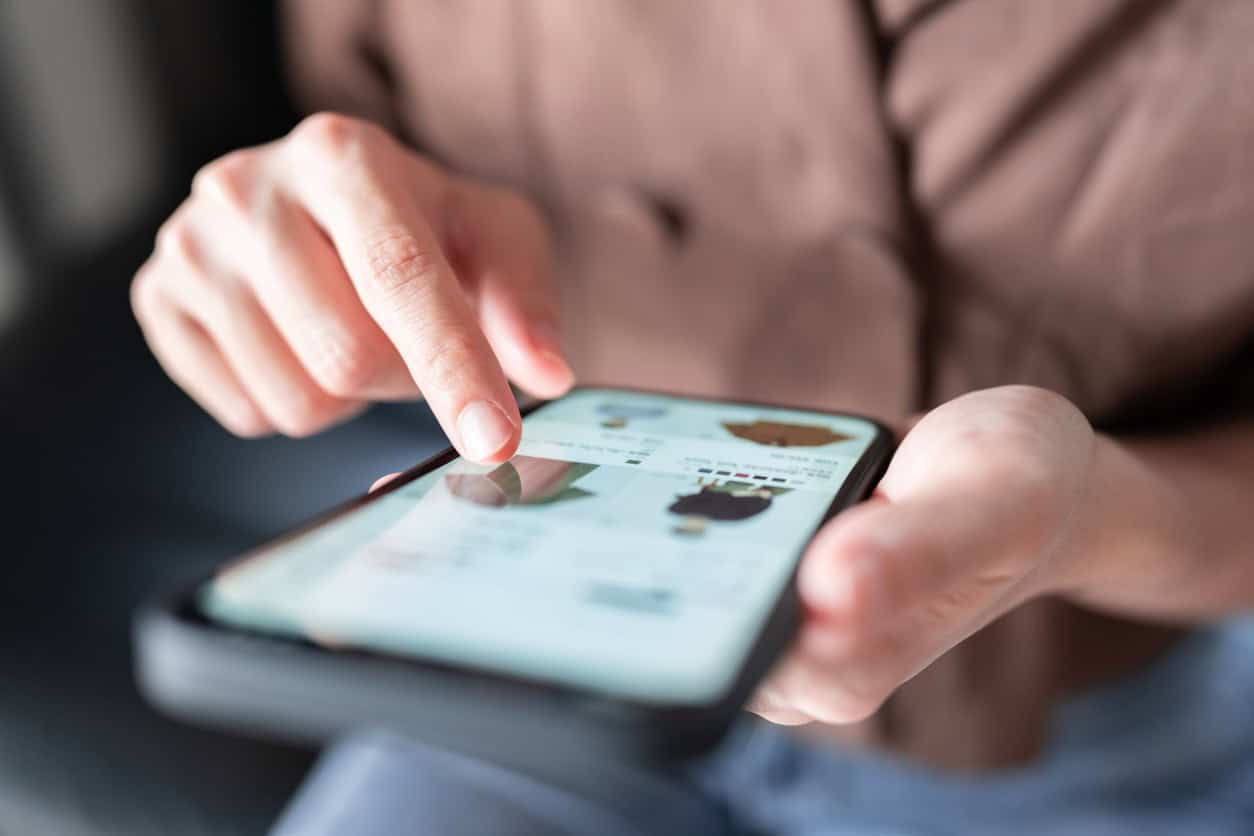 Person browsing products and shopping on a mobile e-commerce app.