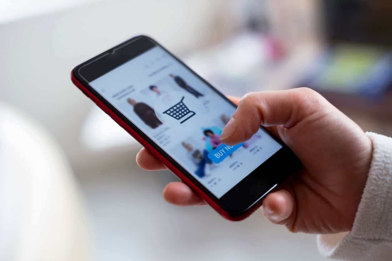 Person browsing products and making a purchase through a mobile shopping app.