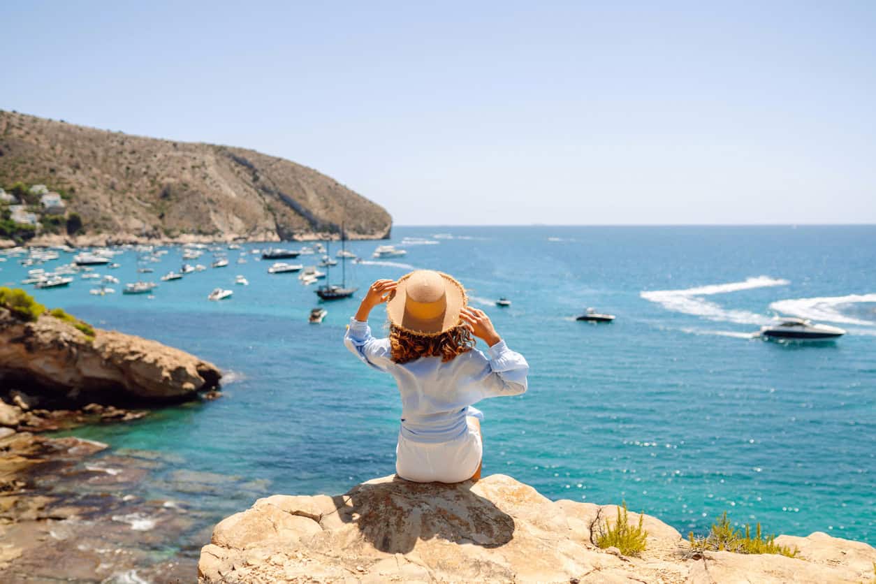 Traveler enjoying a beach vacation booked with points and miles.