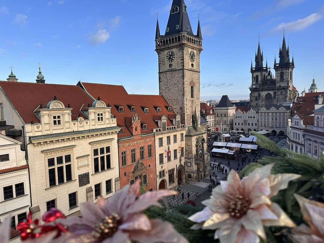Panoramic view of Prague's Old Town Square and the Astronomical Clock from the Terasa U Prince restaurant, with the Church of Our Lady before Týn in the background.