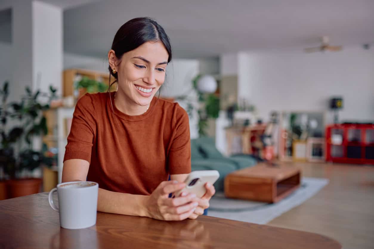 Woman using her smartphone to book a Points & Miles consultation.