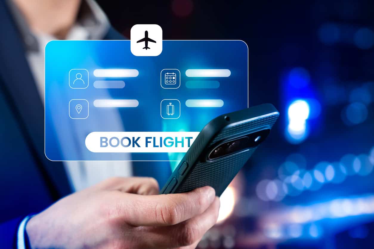 Traveler using a smartphone to book a flight online.